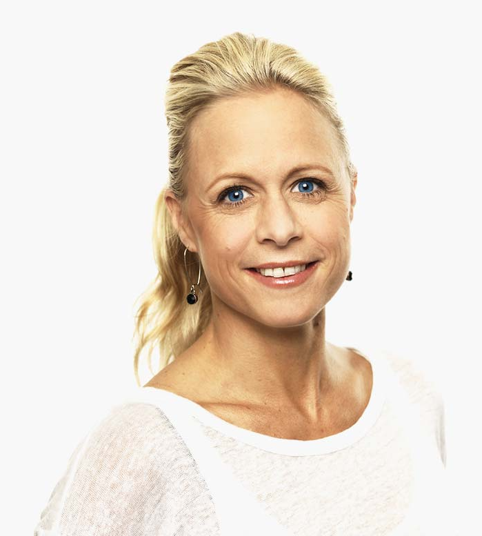 Black and white portrait of a dance instructor posing in front of a dark background.